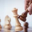 A black chess piece capturing a white piece.