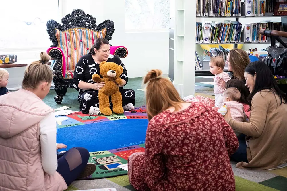 Busselton-Libraries-Baby-Bounce Women sitting in a circle holding babies. One woman is holding a teddy bear.