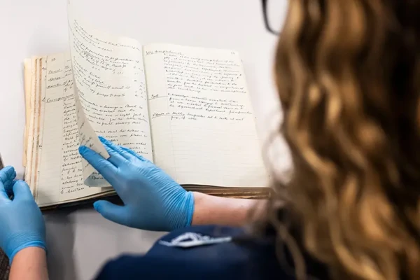 Local-Studies-Archive View over shoulder of a person reading a book.