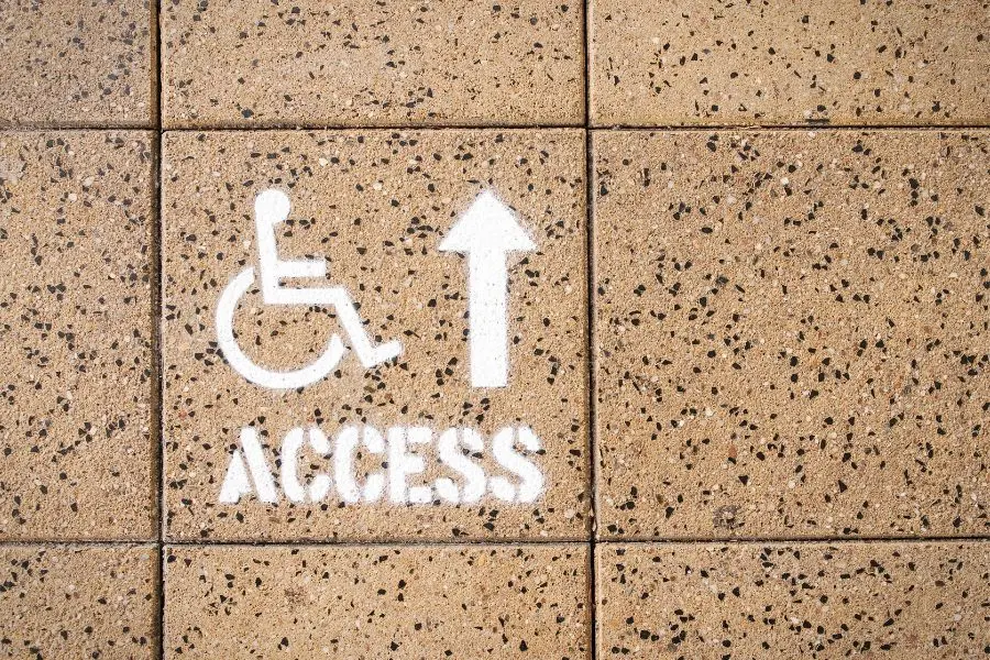 A sign indicating location for disability access.