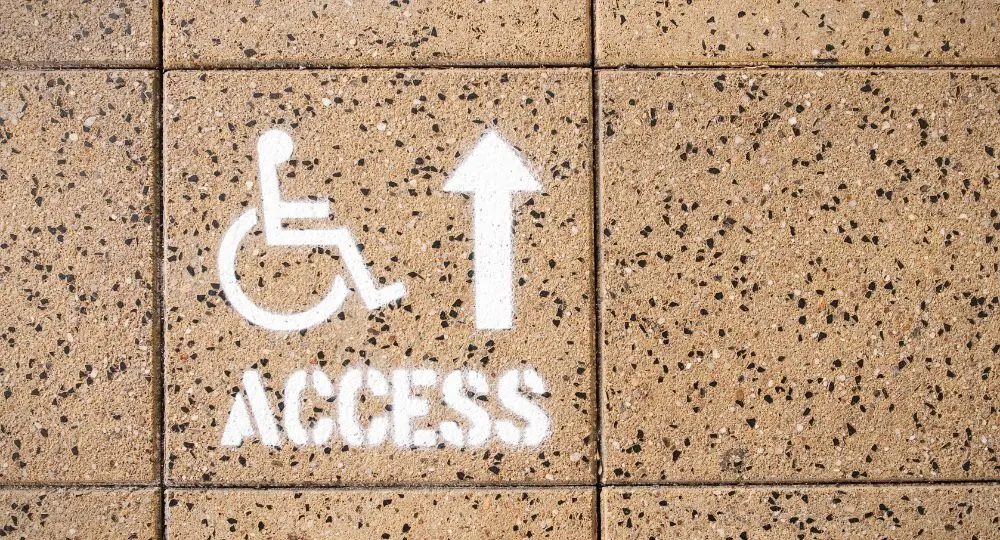 A sign indicating location for disability access.