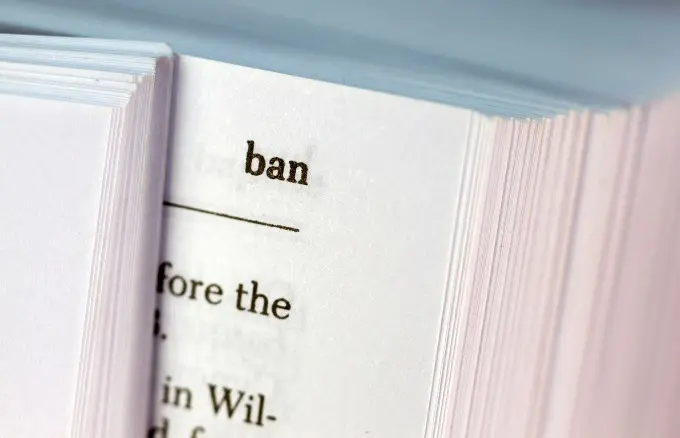 The corner of a book, focusing on the word ban.