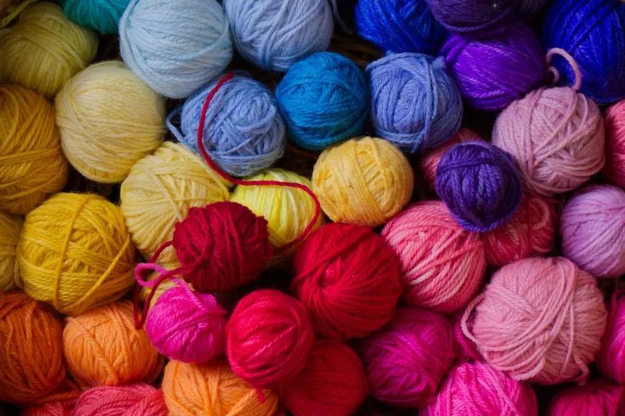 Numerous balls of yarn, in different colours and sizes.