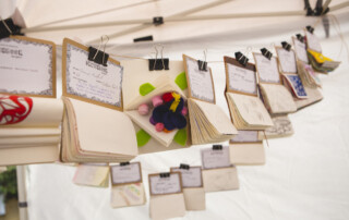 Small skecthbooks hanging on display in a library.
