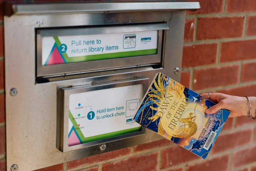 returns-chute A book being used to unlock the Busselton Library external returns chute.