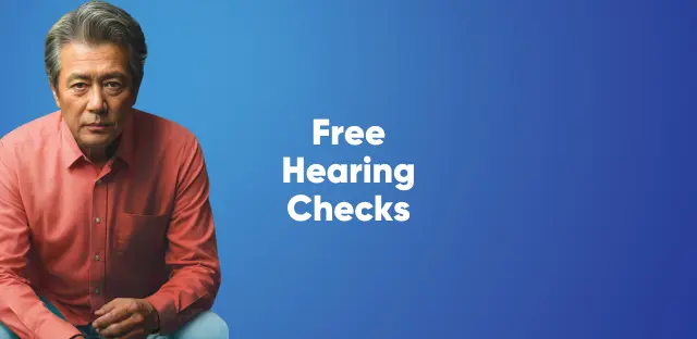 A man infront of a blue background, with the words "free hearing check"