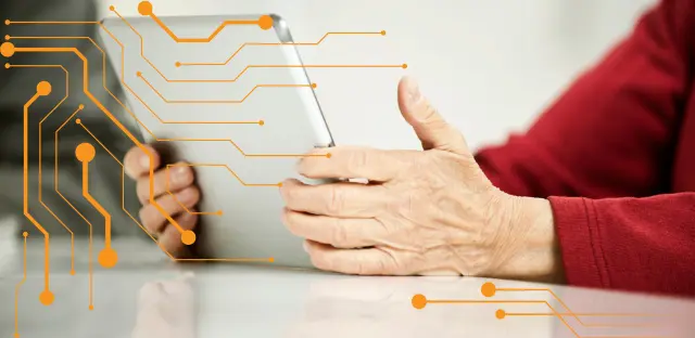 A close-up image of an older woman using an ipad or table.