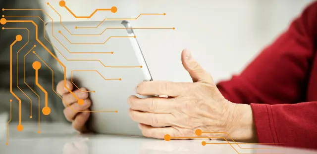 A close-up image of a woman holding an ipad or tablet.